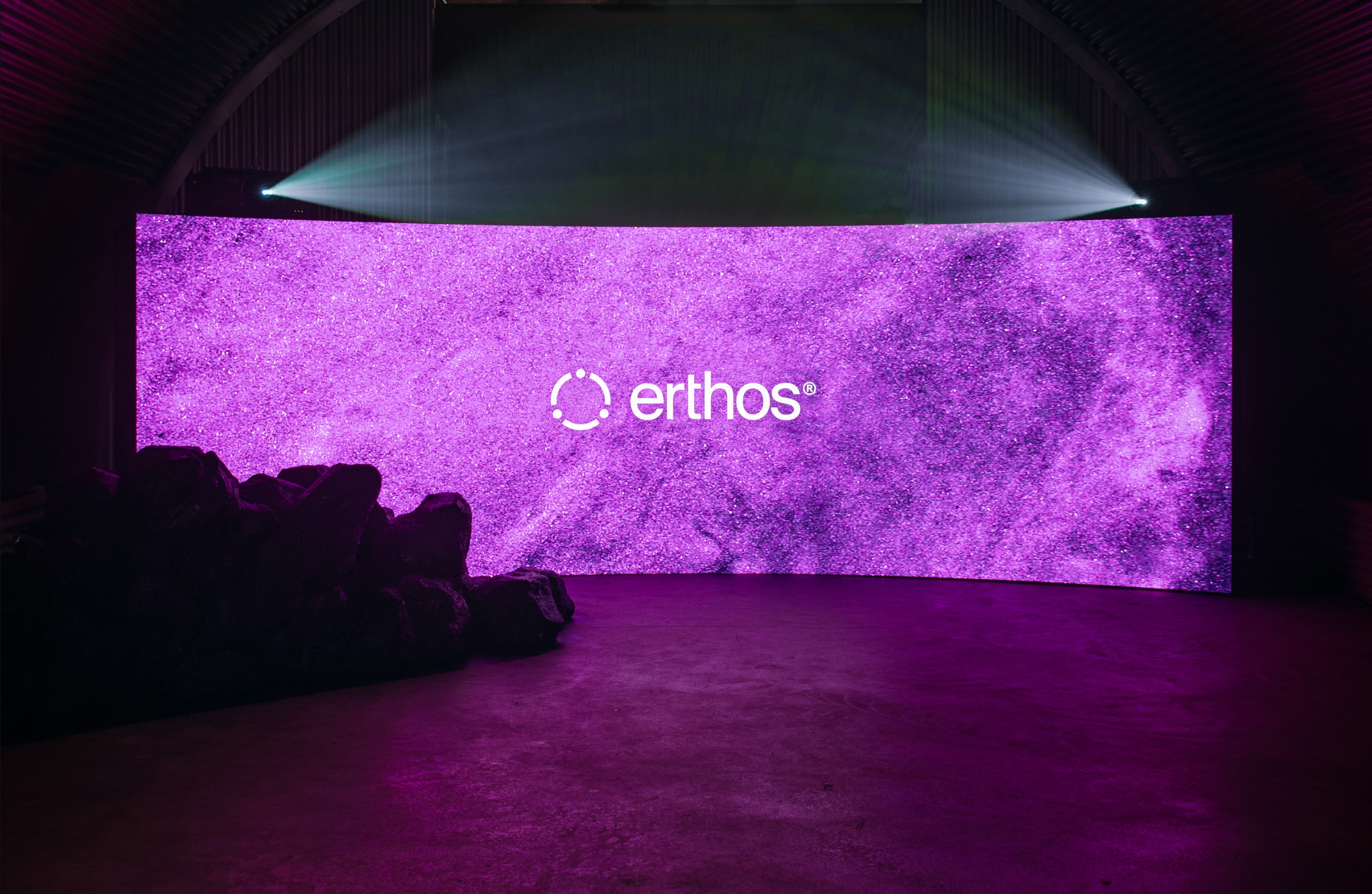 large screen event space with logo