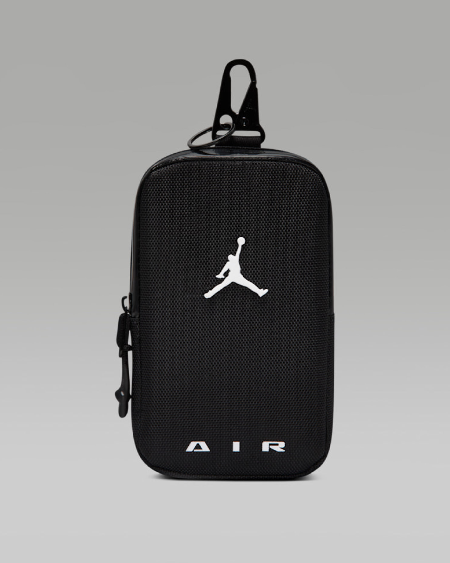 Black textured sling bag with white Jumpman logo and "Air" wordmark, black clip strap