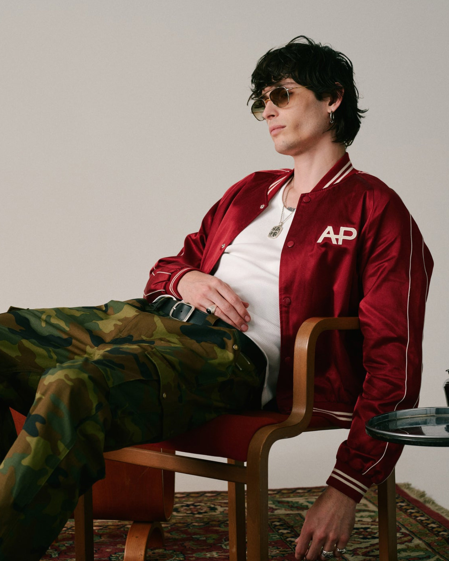 coat,jacket,person,sitting,boy,male,teen,necklace,chair,pants