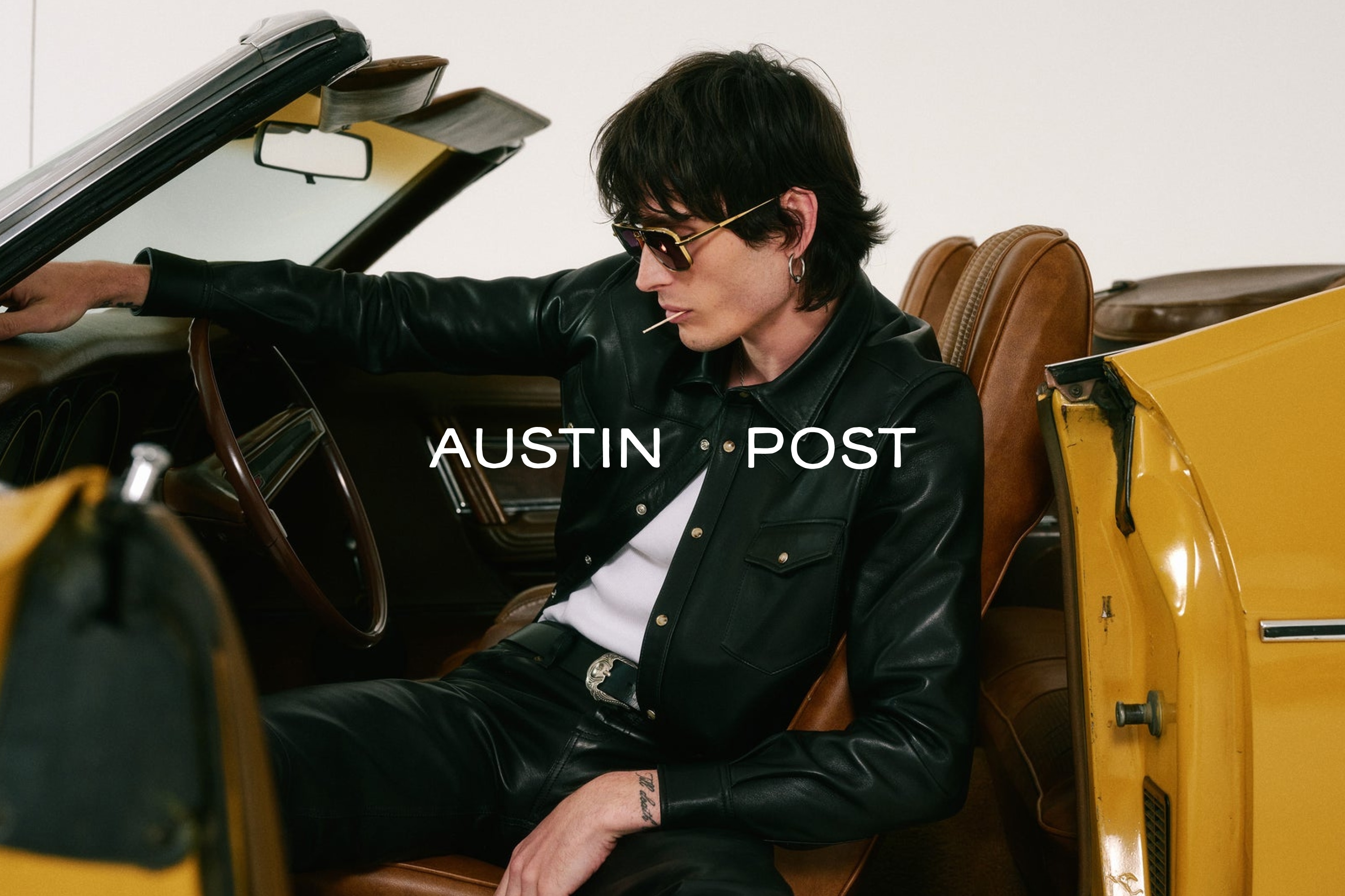 coat,jacket,adult,male,man,person,accessories,glasses,chair,handbag